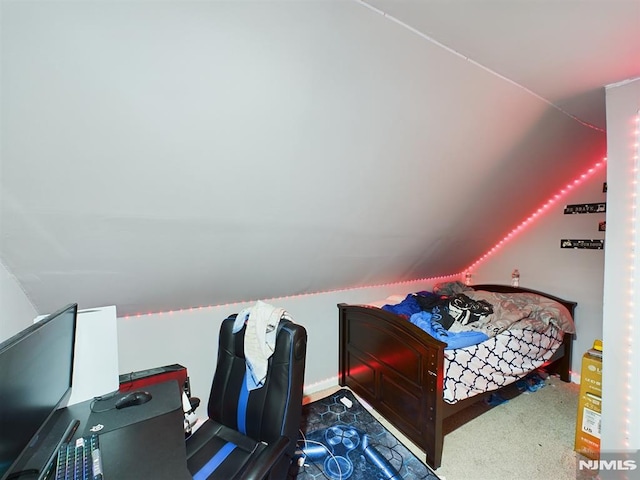 carpeted bedroom featuring lofted ceiling