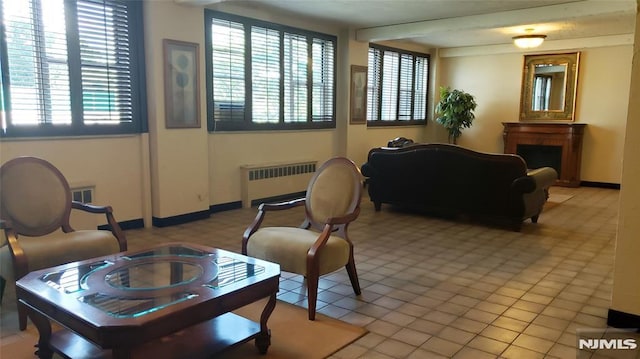 living room with radiator and light tile patterned flooring