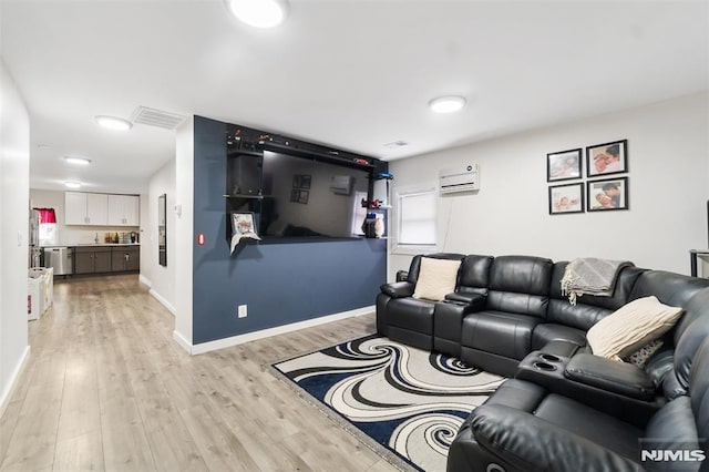 living room with a wall unit AC and light wood-type flooring