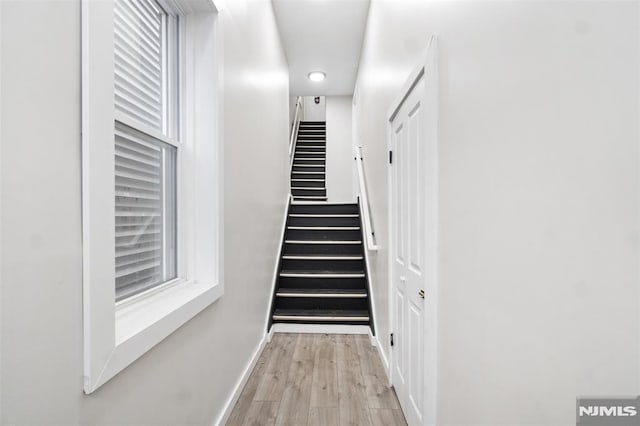 stairway featuring hardwood / wood-style flooring