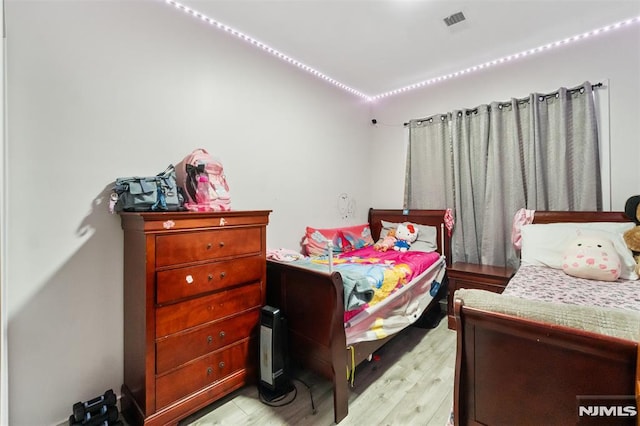 bedroom with light hardwood / wood-style floors