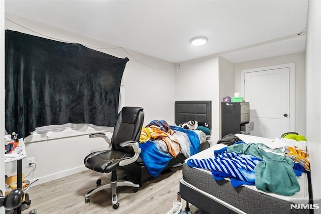 bedroom with light wood-type flooring