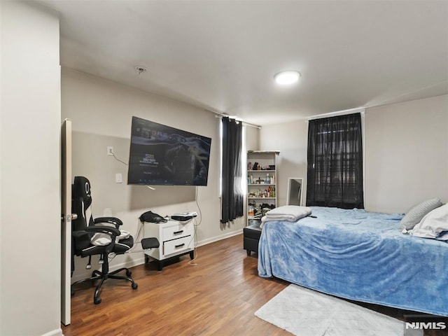 bedroom with hardwood / wood-style flooring