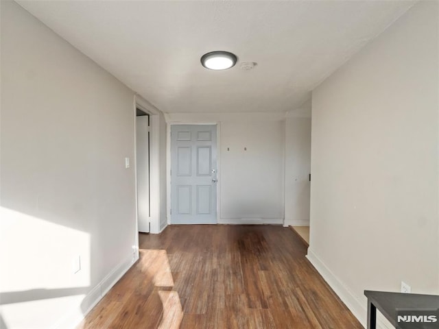 hallway with dark hardwood / wood-style floors