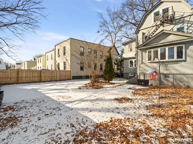 view of snow covered rear of property