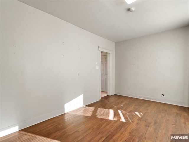 spare room featuring hardwood / wood-style flooring