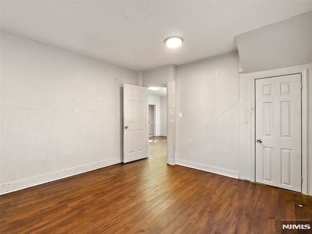 spare room with dark hardwood / wood-style floors