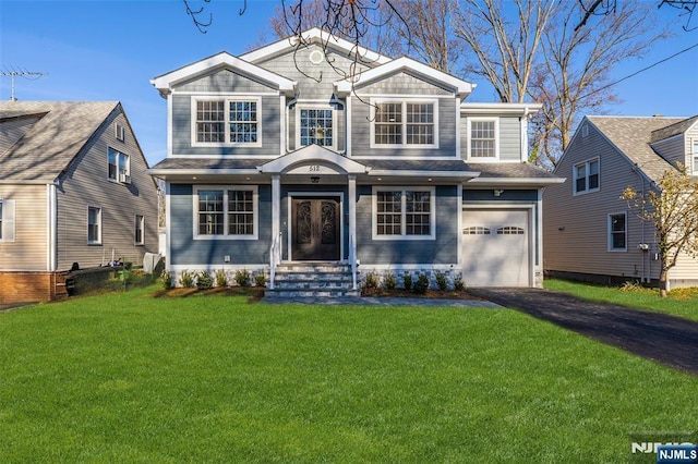 view of front of property featuring a garage and a front lawn