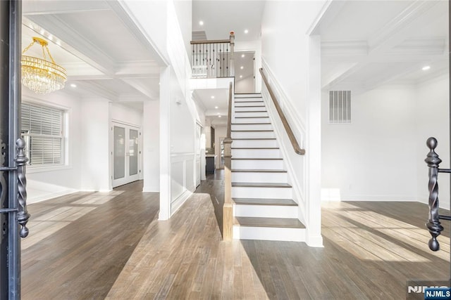 entryway featuring coffered ceiling, beam ceiling, and dark hardwood / wood-style floors