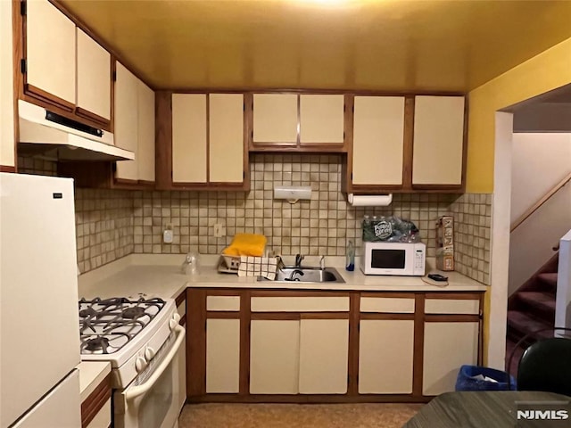 kitchen with sink, white appliances, and decorative backsplash