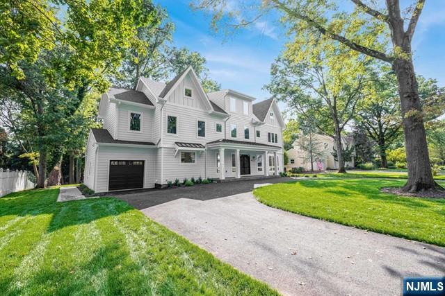 view of front of property featuring a garage and a front lawn