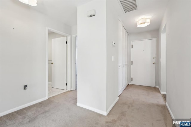corridor with light colored carpet