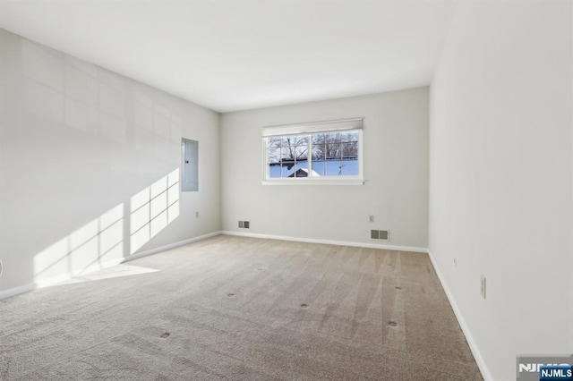 unfurnished room with electric panel and carpet flooring