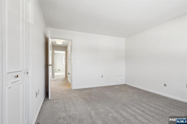 spare room with light colored carpet