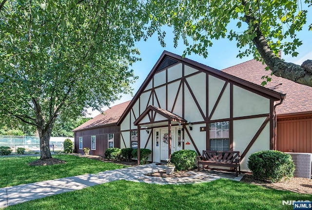 back of property with a yard
