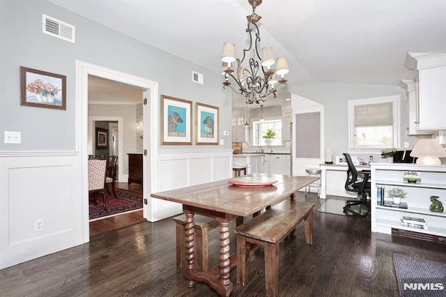 dining space with wainscoting, visible vents, and dark wood finished floors