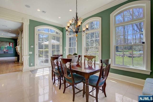 dining space with crown molding and an inviting chandelier