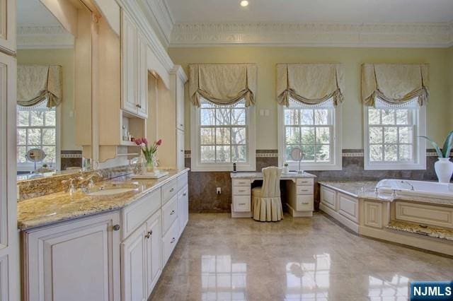 bathroom with ornamental molding and a wealth of natural light