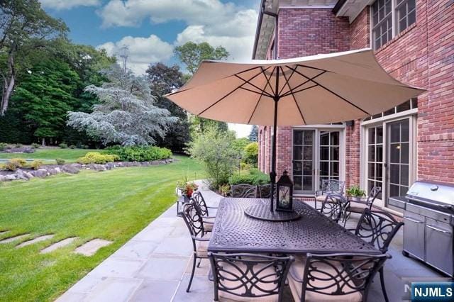 view of patio featuring a grill, french doors, and an outdoor kitchen