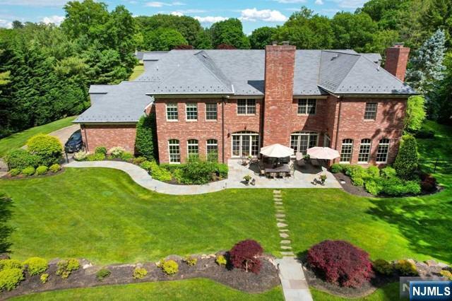 back of house with a yard and a patio