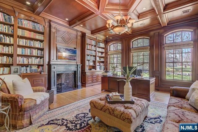 home office featuring crown molding, plenty of natural light, and built in shelves