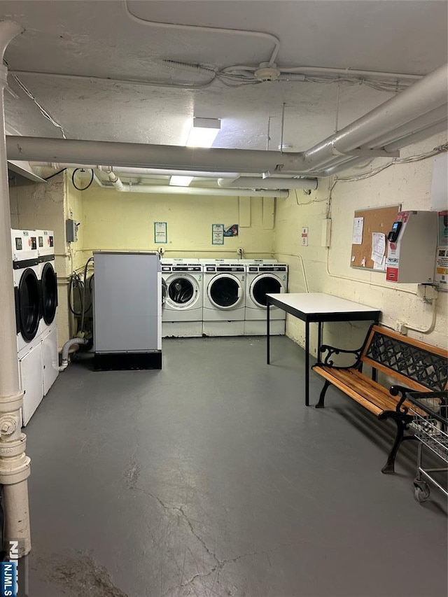 basement with fridge and washing machine and dryer