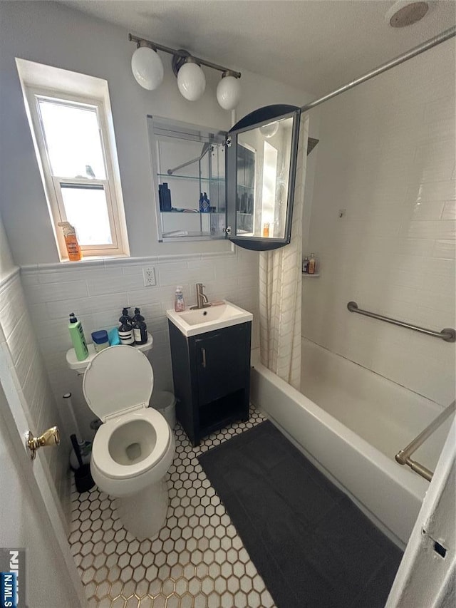 full bathroom featuring vanity, a shower with curtain, tile patterned flooring, tile walls, and toilet