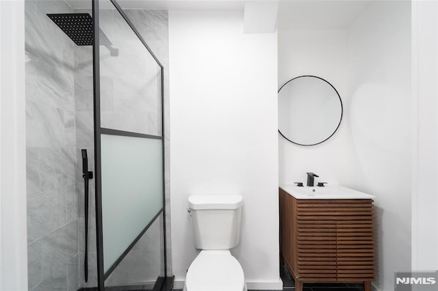 bathroom with vanity, toilet, and a shower with shower door