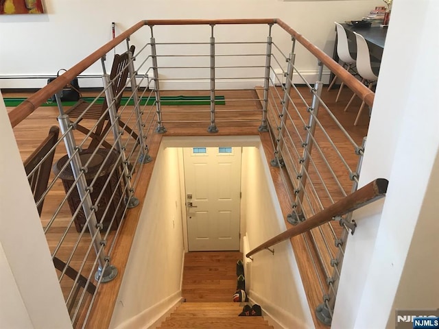 stairway with hardwood / wood-style flooring