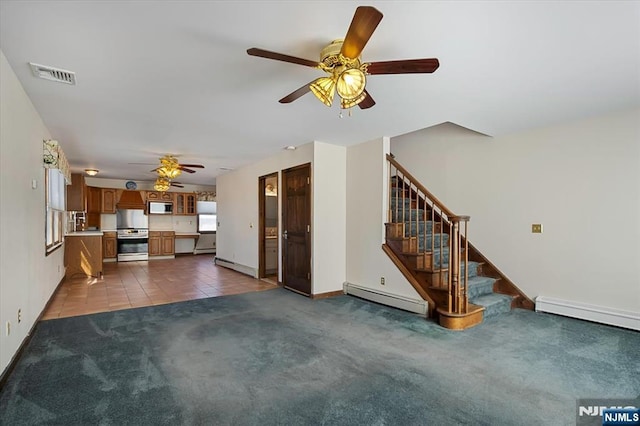 unfurnished living room featuring carpet, visible vents, baseboard heating, and stairs