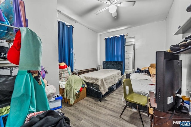 bedroom with light hardwood / wood-style flooring and ceiling fan