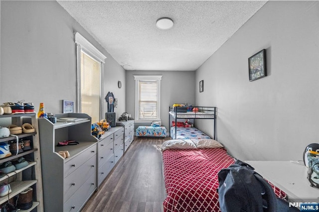 bedroom featuring dark wood-type flooring and a textured ceiling