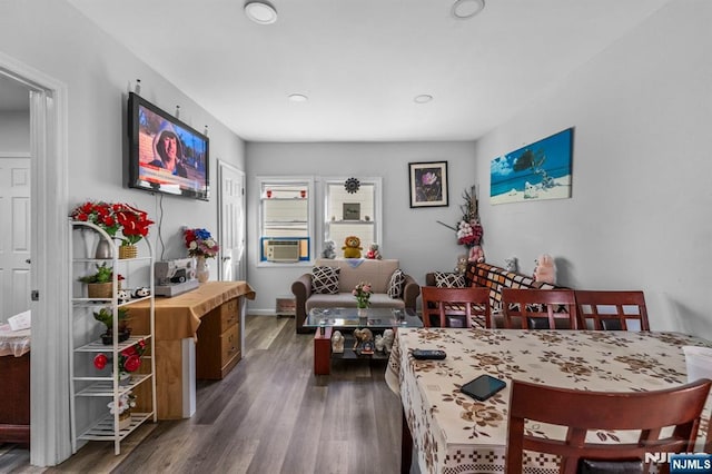 dining room featuring cooling unit and dark hardwood / wood-style flooring