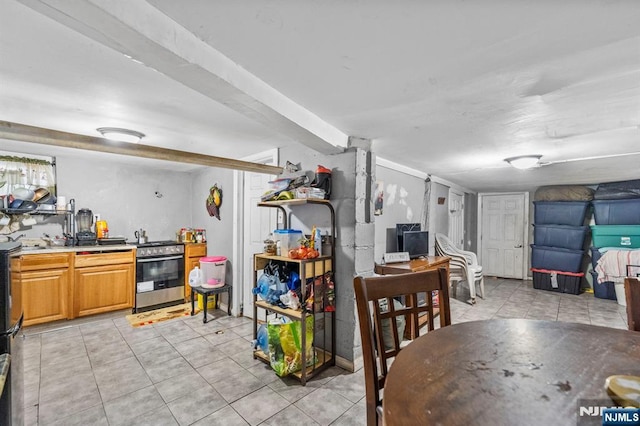 kitchen with stainless steel range with gas cooktop and light tile patterned floors