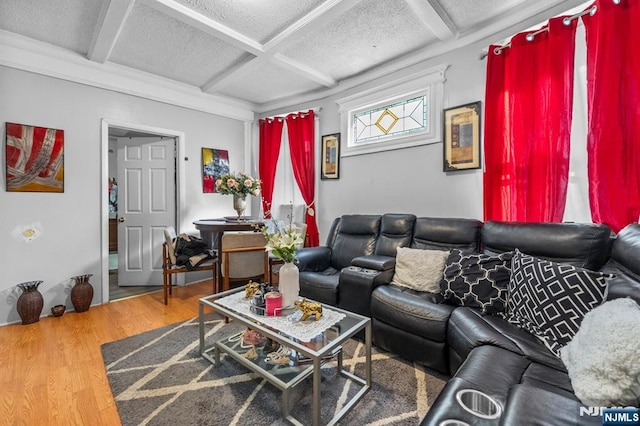 living room with hardwood / wood-style flooring, coffered ceiling, a textured ceiling, and beamed ceiling