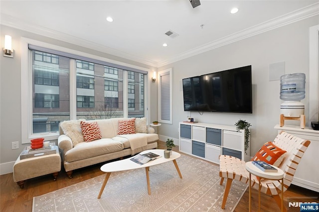 living room with wood-type flooring and ornamental molding