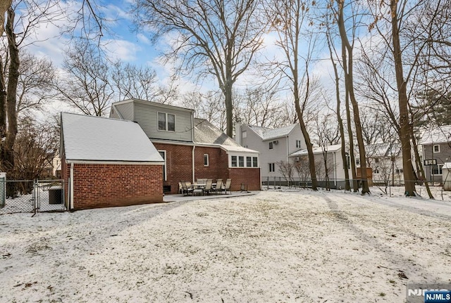 view of snow covered rear of property