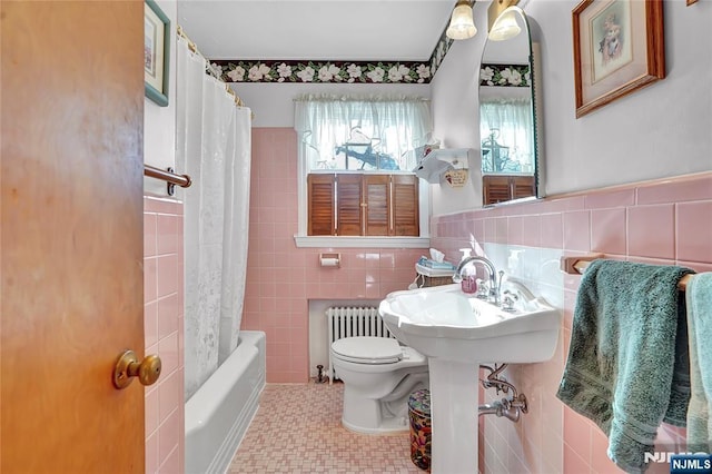 bathroom featuring tile walls, radiator, toilet, and shower / bath combo with shower curtain