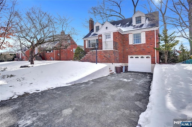 view of snowy exterior with a garage