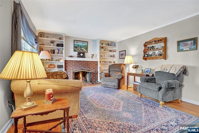 living room featuring hardwood / wood-style floors and a brick fireplace