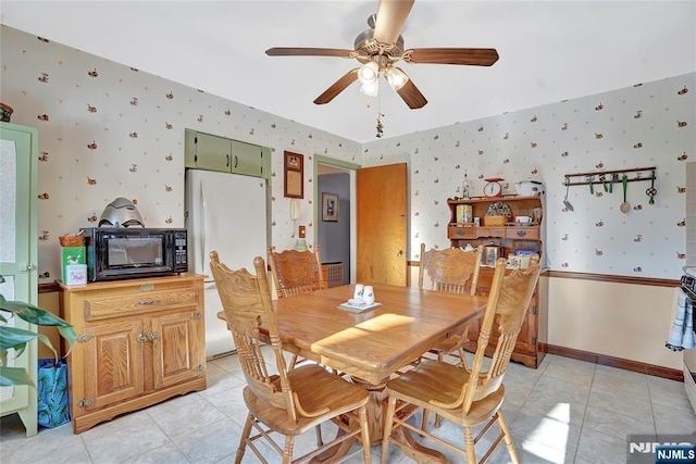 dining space with ceiling fan and light tile patterned floors