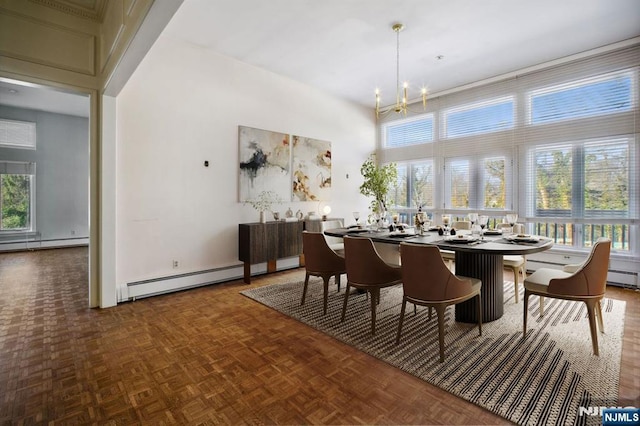 dining room featuring parquet flooring, plenty of natural light, a chandelier, and a high ceiling