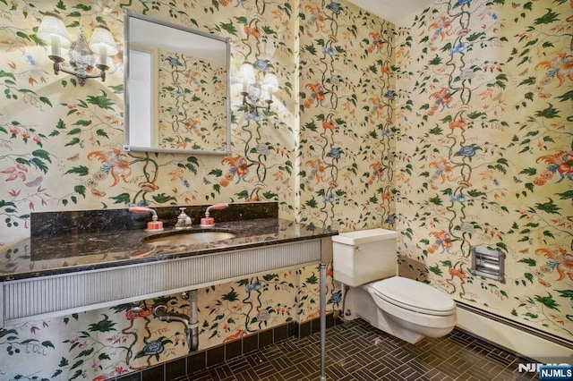 bathroom with vanity, a baseboard heating unit, and toilet