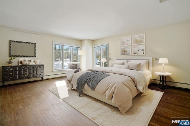 bedroom with a baseboard radiator, access to exterior, and hardwood / wood-style floors