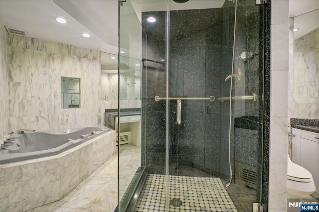 full bathroom featuring toilet, vanity, shower with separate bathtub, and tile walls