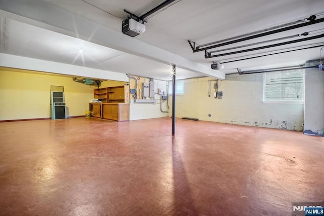 garage with a garage door opener and electric panel