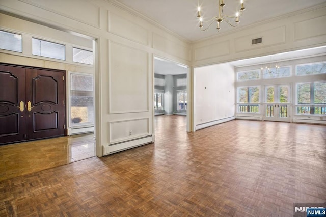 foyer entrance featuring parquet flooring, a baseboard radiator, and a chandelier