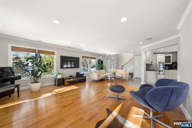 living room with crown molding and light wood-type flooring