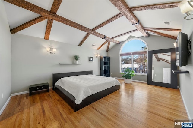 bedroom with vaulted ceiling with beams and light hardwood / wood-style floors