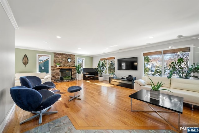 living room with crown molding, a brick fireplace, and light hardwood / wood-style flooring